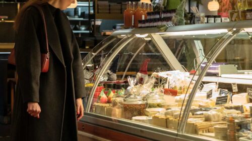 Kvinna shoppar i Uppsala saluhalls ostbod